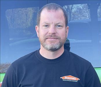 Tim Smith, Construction Manager, standing in front of one of our SERVPRO vehicles.