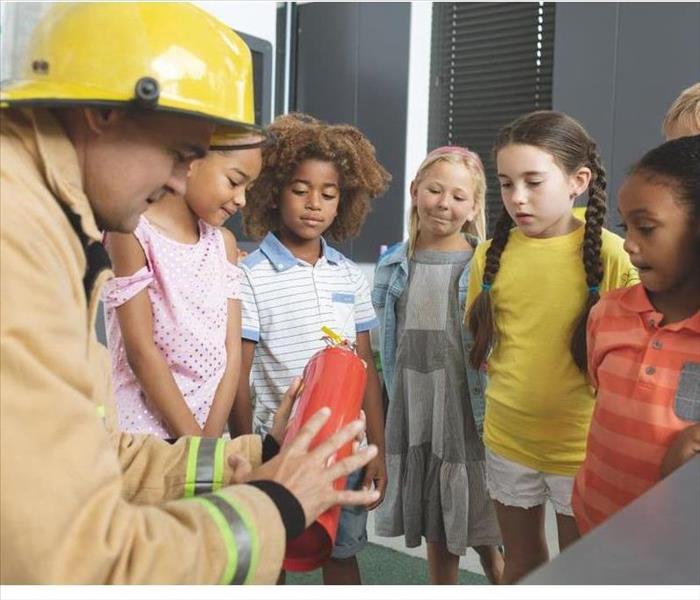 firefighter talking to children